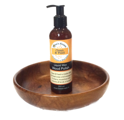 Bee's Knees Clean & Feed Liquid Wax sitting in a wooden bowl